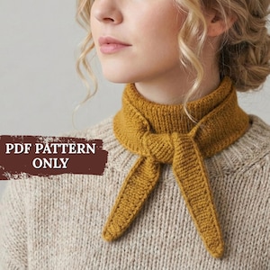 May include: Mustard yellow knitted scarf tied in a knot, worn over a beige knitted sweater. The scarf is a warm, earthy tone, and the sweater has a textured appearance. The text "PDF PATTERN ONLY" is visible on the left side of the image.