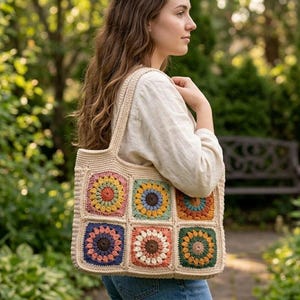May include: A beige crochet tote bag with a colorful patchwork design. The patchwork squares feature various colors, including yellow, orange, blue, and green. The bag has a sturdy handle and is carried over the shoulder.