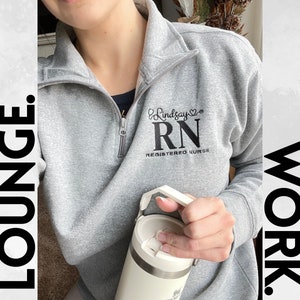 May include: Grey sweatshirt with a black embroidered logo that says "Lindsay RN Registered Nurse".