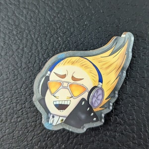 May include: A yellow-haired anime character with sunglasses and headphones, wearing a black jacket with a white shirt underneath. The character is smiling with their eyes closed.
