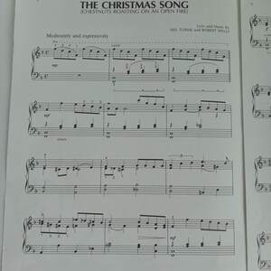May include: Sheet music for "The Christmas Song (Chestnuts Roasting on an Open Fire)" by Mel Torme and Robert Wells. The music is written in black ink on white paper, with musical notes, lyrics, and instructions. The title is at the top.