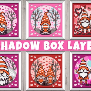 May include: Six layered shadow box designs featuring gnomes with hearts and the words "I Love You". The boxes are pink, red, and white with a white frame.
