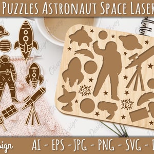 May include: A laser cut wooden puzzle featuring an astronaut, rockets, a telescope, a satellite, and other space-themed elements. The puzzle pieces are designed to fit together to create a complete image. The puzzle is perfect for kids who love space.