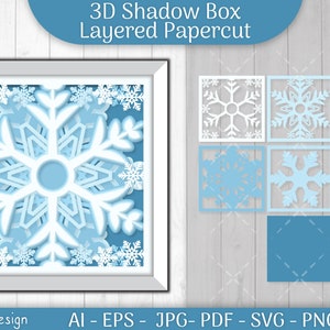 May include: A 3D shadow box papercut design featuring a snowflake in shades of blue and white. The design includes six separate layers for assembly. The image includes the text "3D Shadow Box Layered Papercut" and "By: OtveyDesign".
