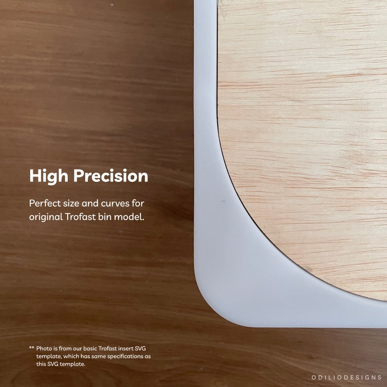 May include: A close-up of a white Trofast insert template for a wooden bin. The template is cut to fit the bin perfectly. The text "High Precision" is visible in the image. The text "Perfect size and curves for original Trofast bin model." is also visible in the image. The text "Photo is from our basic Trofast insert SVG template, which has same specifications as this SVG template." is visible in the image. The text "ODILIODESIGNS" is visible in the image.