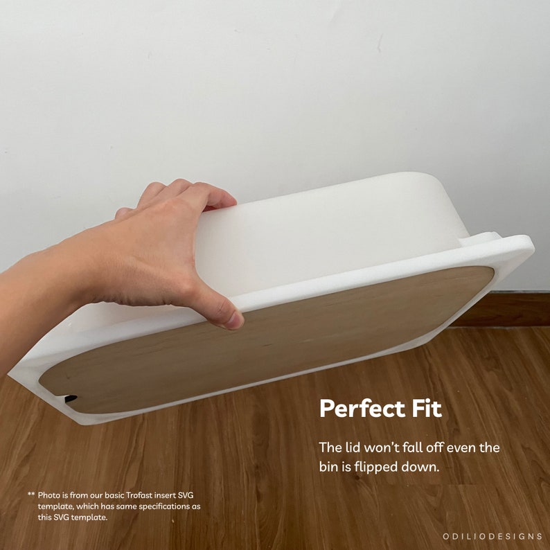 May include: White plastic storage bin with a wooden lid. The lid fits snugly and won't fall off even when the bin is flipped upside down. "Perfect Fit" is written in black text on the wooden lid.