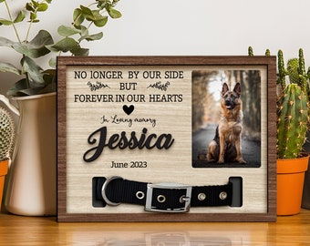 May include: A wooden memorial frame with a photo of a German Shepherd dog. The frame has the text "NO LONGER BY OUR SIDE BUT FOREVER IN OUR HEARTS" and "In Loving memory Jessica June 2023".