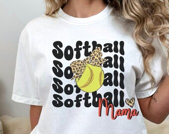 May include: White t-shirt with a black and white graphic design that says "Softball Mama" with a softball and a leopard print bow on top of the ball.