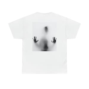 Puede incluir: Una camiseta blanca con una imagen en blanco y negro de la silueta de una persona detrás de una superficie translúcida, con las manos extendidas.