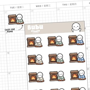 May include: A sheet of stickers featuring a cartoon character sitting by a fireplace. The stickers are in various colours, including blue, green, brown, and white. The text "Cozy me time" and "Bubu Studio" are visible on the sheet.