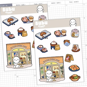 May include: Two sticker sheets featuring illustrations of baked goods, coffee, and a butter cookie shop. The stickers include images of cookies, coffee cups, and a shop with the text "Butter Cookie Shop 42". The brand name "Bubu Studio" is also visible.