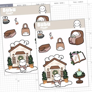 May include: Two sticker sheets featuring cozy winter-themed illustrations. The stickers include a house, a person in a scarf, a mug, a blanket, a bag, and a person reading in a chair. The brand name "Bubu Studio" is visible on the stickers.