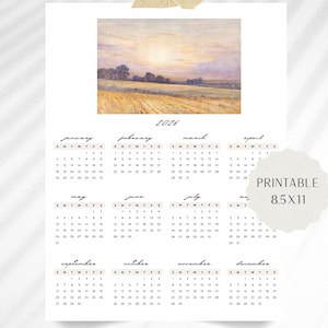 Op de afbeelding: Een printbare kalender voor 2026 met een landschapsschilderij. De kalender, 21,6 x 27,9 cm, heeft een maandelijkse indeling met data en dagen van de week. De achtergrond is wit met de tekst "Printable 8.5x11".
