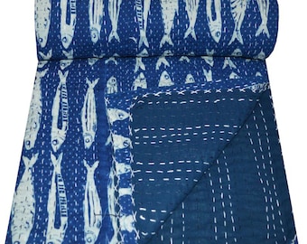 May include: A blue kantha quilt with a white fish pattern. The quilt is folded in half and has a white stitching detail.