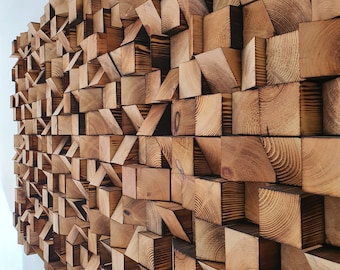 May include: A wall made of many wooden blocks of different sizes and shapes. The blocks are arranged in a random pattern, creating a unique and interesting texture. The wood is a light brown color, and the blocks are all slightly different shades.