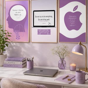 May include: Three framed wall art prints in shades of purple featuring motivational quotes. The left print shows a silhouette of a head, the centre shows a laptop with a keyboard, and the right shows an apple shape. The text includes Strategy is figuring out what NOT to do, Do not try to do everything. Do one thing well, and Innovation distinguishes between a leader and a follower.