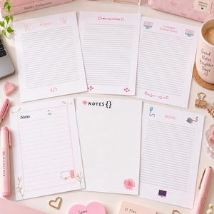 May include: A collection of pink and white stationery featuring lined note sheets with programming icons, heart motifs, and text including "My Notes," "Computer Science Notes," and "Same Girl Smarter Code." The set includes a spiral notebook, pens, and sticky notes.