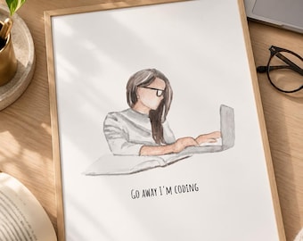 May include: A framed watercolour print featuring a person with long brown hair wearing glasses, sitting at a desk and typing on a laptop. Below the illustration, the text reads, "GO AWAY I'M CODING" in a simple, black, sans-serif font.