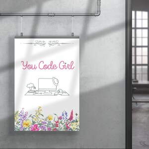 May include: A white poster with the text "You Code Girl" in pink lettering. A line drawing of a computer desk with a computer, a plant, and a hat on top of the computer is below the text. The bottom of the poster has a border of colourful flowers.