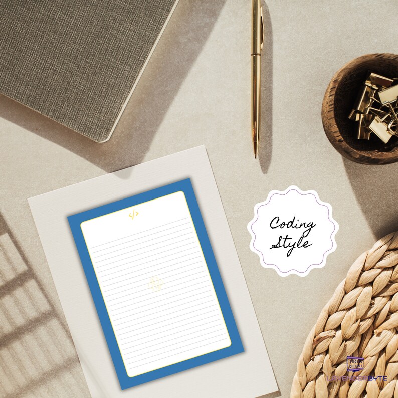 May include: A blue lined notepad with a yellow coding symbol at the top. The notepad is on a white surface with a white sticker that says "Coding Style" on it.