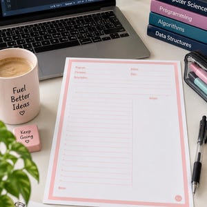 May include: A white programming worksheet with a pink border featuring fields for program, author, file name, date, description, and output. The sheet includes a numbered list area and a notes section, displayed alongside a laptop, mugs, and books.
