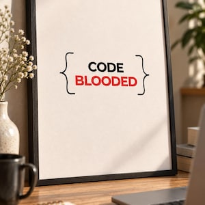 May include: A framed vertical print featuring a white background with black curly brackets enclosing the text CODE in black and the word BLOODED in red. The frame is thin and black, surrounding the off-white paper with a clean, centred design.