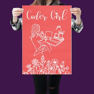 May include: A pink poster with white line art of a person sitting at a desk with a laptop and a cup of coffee. The text "Coder Girl" is at the top of the poster with a small heart symbol. The bottom of the poster has a row of white line art flowers.