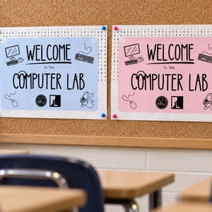 May include: Two rectangular signs with a binary code border, one light blue and one light pink. Both feature the text "WELCOME To The COMPUTER LAB" in black, accompanied by line art icons of a computer, keyboard, mouse, headphones, and signs.