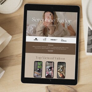 May include: A tablet screen displaying a website for Seraphine Taylor, a beauty and lifestyle influencer. The website features a photo of Seraphine, a list of brands she collaborates with, and a section titled "Top Viewed Videos".