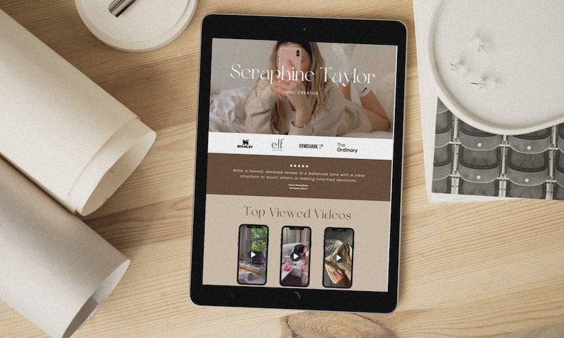 May include: A tablet screen displaying a website for Seraphine Taylor, a beauty and lifestyle influencer. The website features a photo of Seraphine, a list of brands she collaborates with, and a section titled "Top Viewed Videos".
