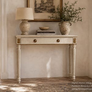 May include: A cream-coloured console table with a single drawer, featuring gold-toned circular pulls and decorative floral accents on the corners. The table has four fluted legs and a rectangular top, presented in a neutral-toned room setting.