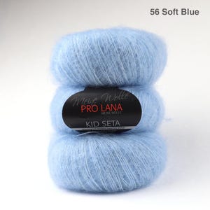 May include: A skein of soft blue yarn labelled "Meine Wolle Pro Lana Kid Seta".