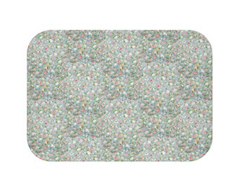 May include: A light blue fabric with a small floral pattern in shades of pink, white, and green.