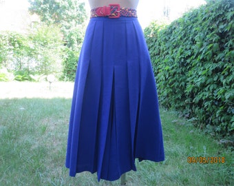 May include: A royal blue pleated skirt with a wide, colorful belt. The skirt is knee-length and has a flared silhouette.