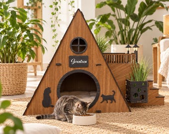 May include: A triangular wooden cat house with a dark brown finish, featuring a circular entrance, a small window, and a plaque labeled Seventeen. The structure includes a side staircase, a balcony with two small lamps, and black cat silhouettes.