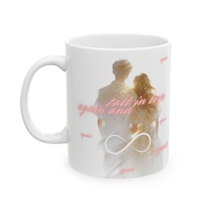 May include: White ceramic mug featuring a romantic illustration of a couple with the words "again fall in love" and an infinity symbol. The design has a soft, dreamy aesthetic with a touch of gold.