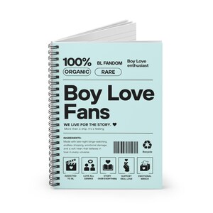 May include: A spiral-bound notebook with a light blue cover featuring the text "Boy Love Fans." The cover includes the words "100% Organic" and "Rare." Additional text includes "We live for the story. More than a ship. It's a feeling."