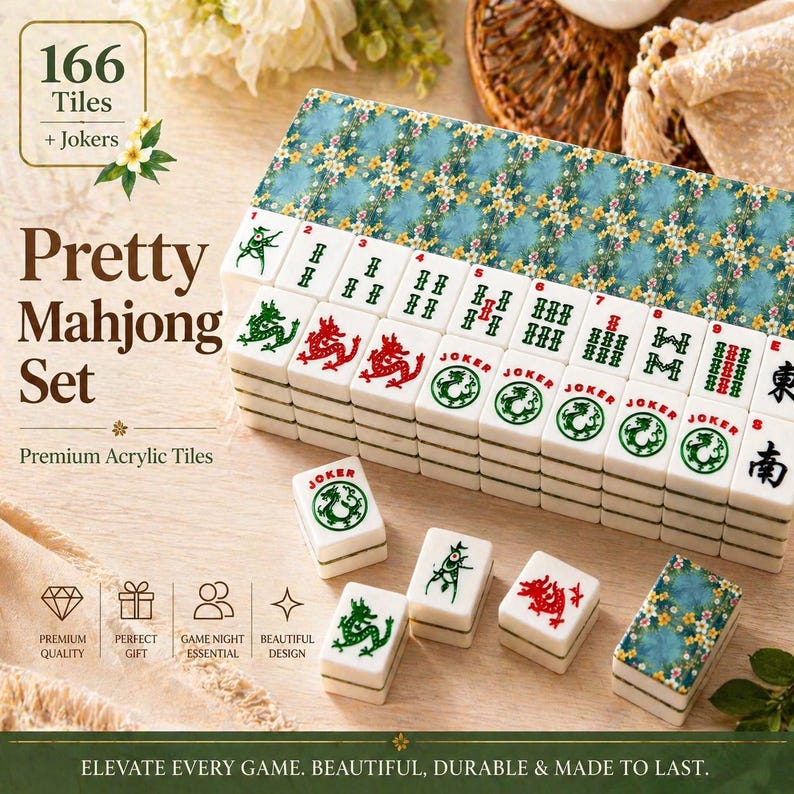May include: A Pretty Mahjong Set with 166 tiles and Jokers. The set includes premium acrylic tiles with green and red dragon designs, and a blue floral patterned case. The text on the box says "Elevate every game. Beautiful, durable & made to last."