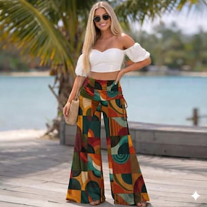 May include: A woman wearing a white off-the-shoulder crop top and wide-leg pants with a geometric pattern. The pants feature a mix of colors including orange, green, and brown. She is also wearing sunglasses and carrying a woven bag. The background includes a beach and palm trees.