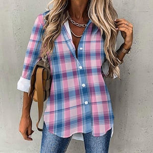 May include: A pink and blue plaid long-sleeved shirt with a white button-up front.