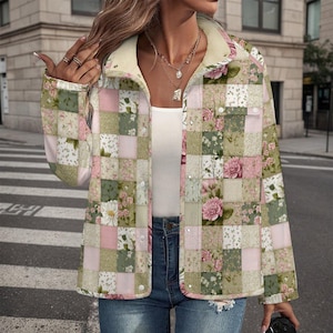 May include: A patchwork jacket featuring a floral pattern in shades of pink, green, and white. The jacket has a cream-colored collar and is buttoned up. The jacket is worn over a white top and blue jeans.