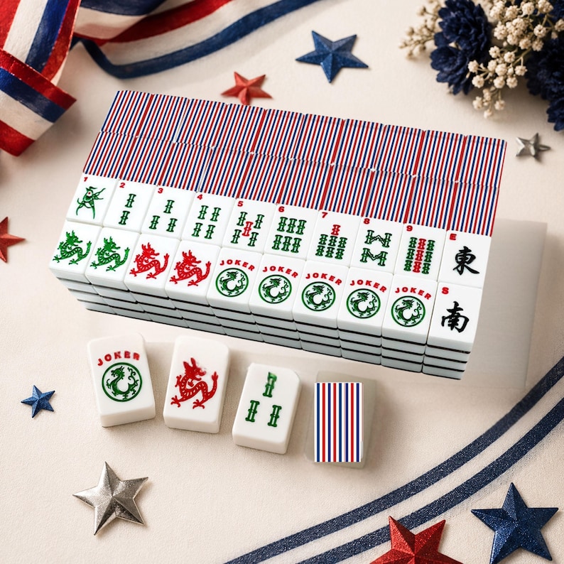 May include: A set of white mahjong tiles featuring red, white, and blue striped backs. The tiles display various green and red symbols, dragon illustrations, and the word Joker. Some tiles show Chinese characters for East and South directions.