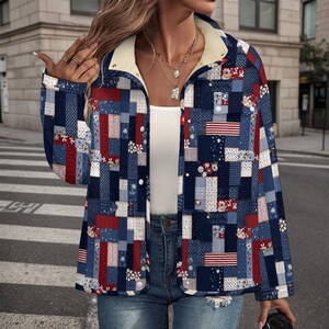 May include: A patchwork jacket in shades of blue, red, and white, featuring a mix of floral, striped, and star patterns. The jacket has a cream-colored sherpa lining at the collar and cuffs, and is buttoned up. The jacket is worn with blue jeans.