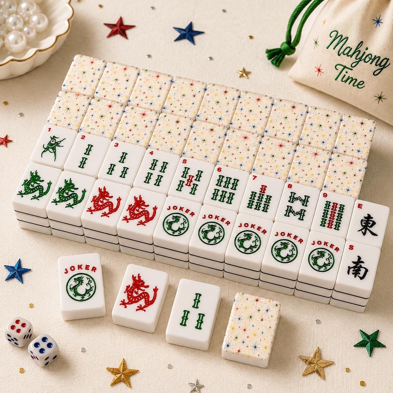 May include: A set of white Mahjong tiles featuring green and red character designs, including Joker tiles and tiles with numbered sequences. The backs of the tiles have a colorful star pattern. A drawstring bag labeled Mahjong Time is included.