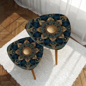 May include: Two decorative side tables with a unique design. The tables have a triangular shape with rounded edges. The tabletop features a blue and gold mandala pattern. The tables have wooden legs and are placed on a white rug.