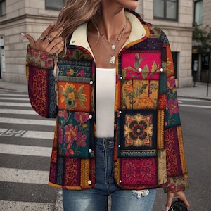 May include: A patchwork jacket with a cream-colored sherpa collar and white snap closures. The jacket features a variety of floral and geometric patterns in shades of red, blue, green, and orange. The jacket is worn over a white top and blue jeans.