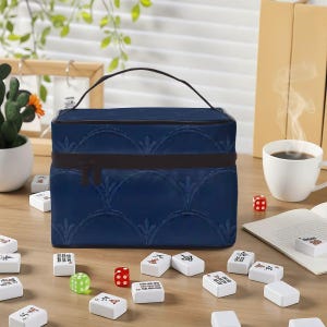 May include: A rectangular dark blue storage case with a top handle and a repeating embossed fan-like pattern. The case features a dark brown zipper closure running horizontally across the front, providing a secure storage solution for game pieces.