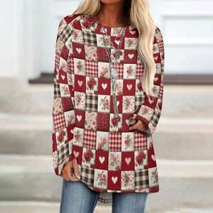 May include: A long-sleeved top with a patchwork design featuring red, white, and brown squares. The squares are decorated with hearts, floral patterns, and gingham checks. The top has a round neckline and a loose fit.