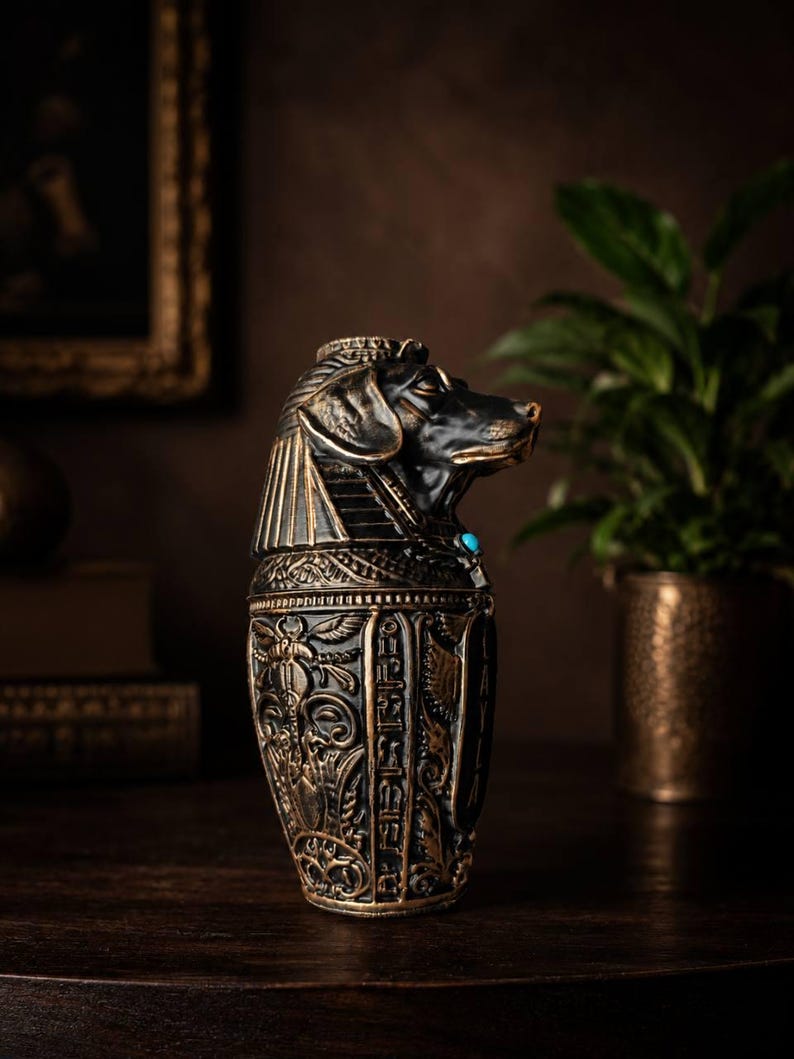 Side view of dog shaped canopic jar pet urn in black and gold cast stone