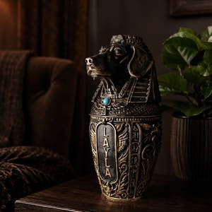 Personalised stone pet urn styled on a dark side table
